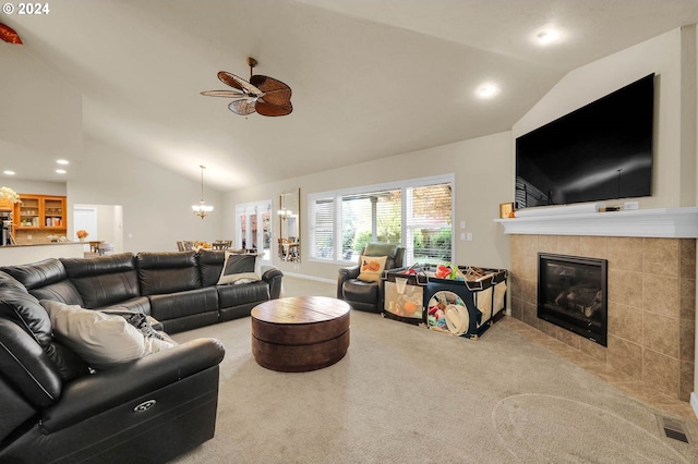 carpeted living room with a tile fireplace, recessed lighting, ceiling fan with notable chandelier, visible vents, and vaulted ceiling