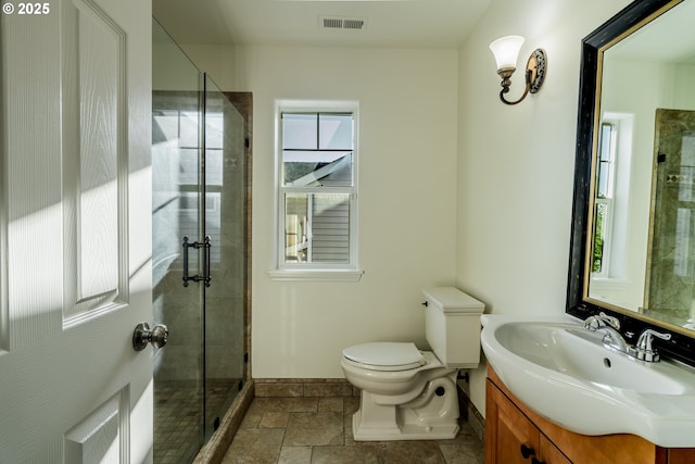 bathroom featuring vanity, an enclosed shower, and toilet