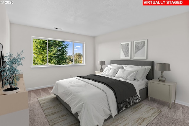 bedroom featuring carpet flooring and a textured ceiling