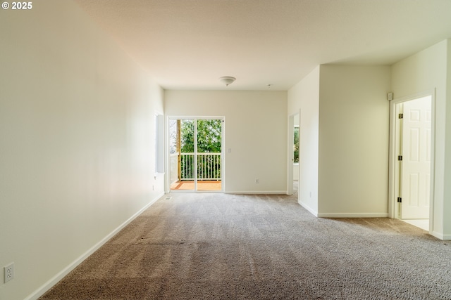 unfurnished room featuring light carpet