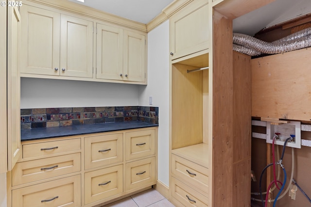 kitchen featuring light tile patterned floors and cream cabinets