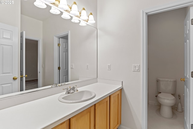 bathroom featuring vanity and toilet