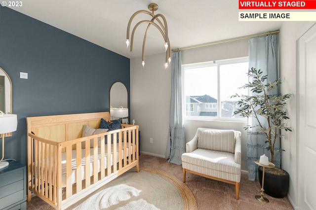 bedroom featuring a crib and carpet flooring