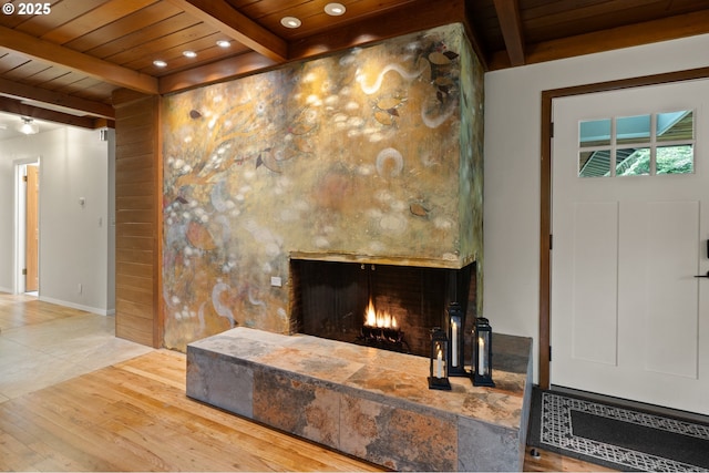 3144 Diane Dr, Lake Oswego, OR 97035 - living room featuring wooden ceiling, beamed ceiling, wood finished floors, and a lit fireplace