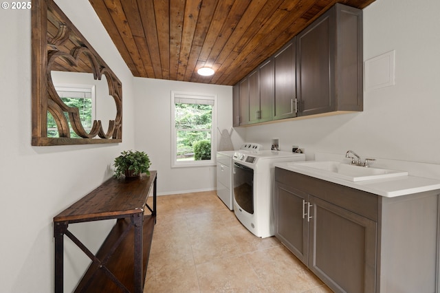 3144 Diane Dr, Lake Oswego, OR 97035 - laundry room featuring wood ceiling, cabinet space, washing machine and clothes dryer, and baseboards