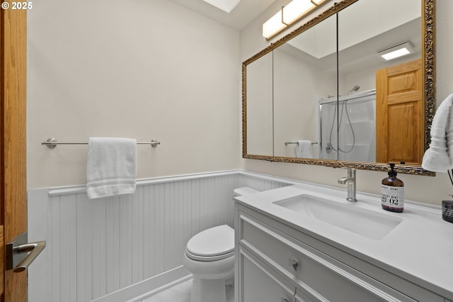 3144 Diane Dr, Lake Oswego, OR 97035 - bathroom featuring a wainscoted wall, a shower with shower door, toilet, and vanity