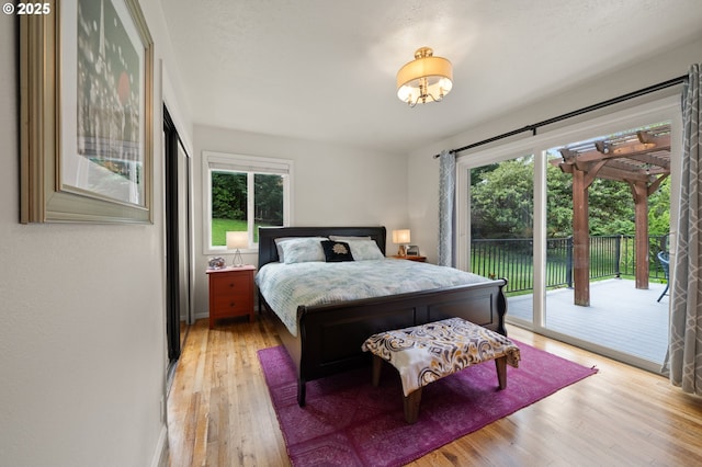 3144 Diane Dr, Lake Oswego, OR 97035 - bedroom featuring access to outside, light wood finished floors, a chandelier, and baseboards