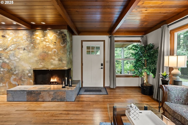 3144 Diane Dr, Lake Oswego, OR 97035 - foyer featuring wood-type flooring, wooden ceiling, beamed ceiling, a stone fireplace, and baseboards