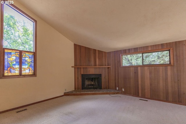 2116 Sally Way, Eugene, OR 97401 - unfurnished living room featuring carpet, a large fireplace, wooden walls, and vaulted ceiling