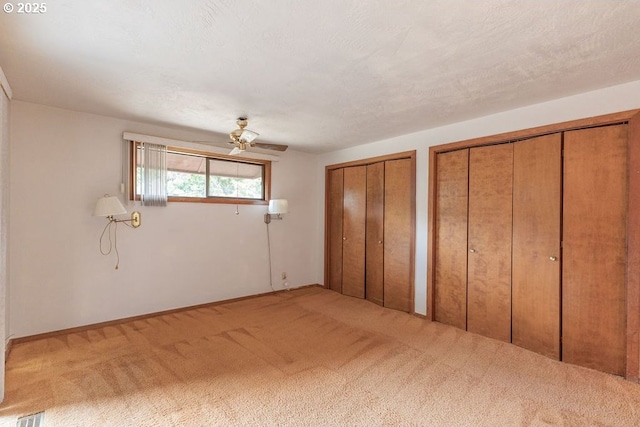 2116 Sally Way, Eugene, OR 97401 - unfurnished bedroom with multiple closets, carpet flooring, and a ceiling fan