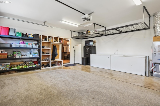 655 Schemmel Ln, Silverton, OR 97381 - garage featuring freestanding refrigerator and a garage door opener