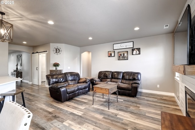 living room with hardwood / wood-style flooring and a barn door