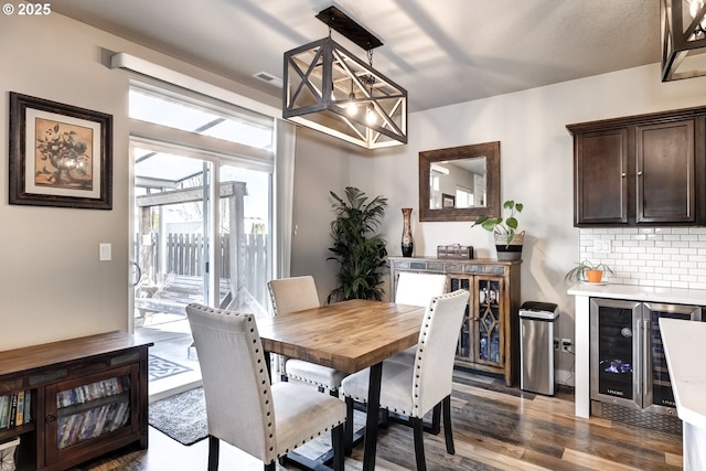 dining space with dark wood-type flooring and wine cooler