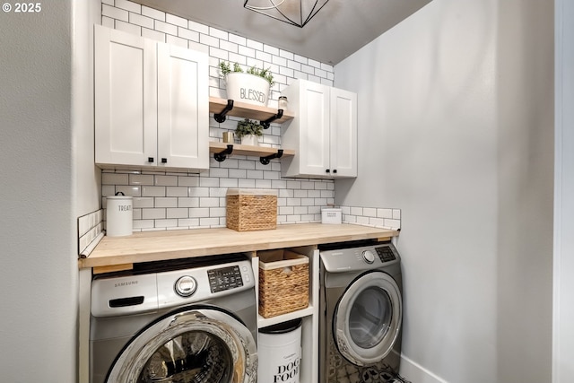 washroom featuring cabinets and washer and dryer