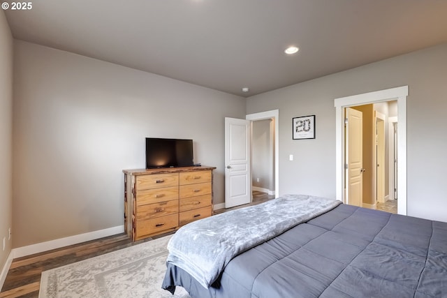 bedroom with dark hardwood / wood-style floors