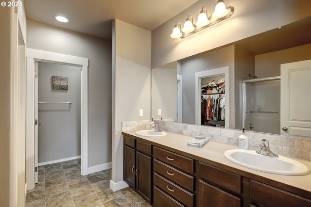 bathroom featuring vanity and a shower with shower door