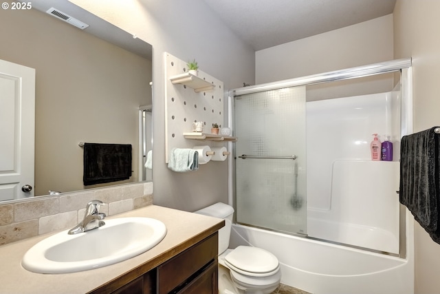 full bathroom with vanity, backsplash, toilet, and combined bath / shower with glass door