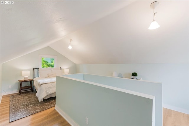 1716 N Rosa Parks Way, Portland, OR 97217 - bedroom with wood finished floors, vaulted ceiling, and baseboards