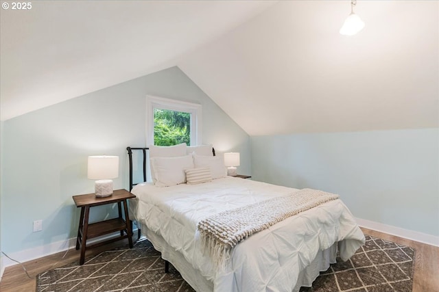 1716 N Rosa Parks Way, Portland, OR 97217 - bedroom featuring dark wood-style flooring, vaulted ceiling, and baseboards