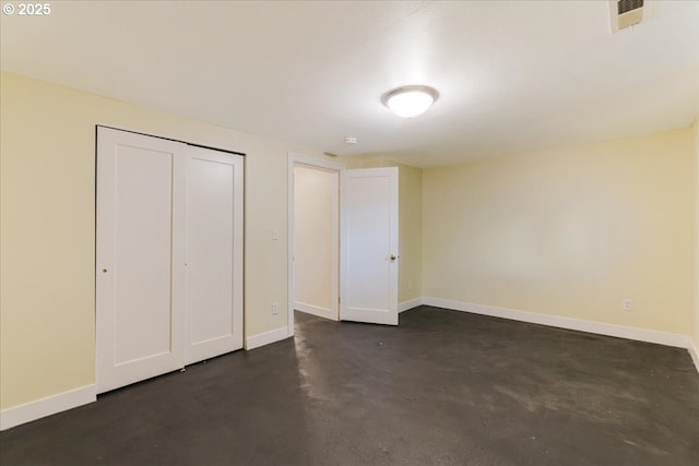 1716 N Rosa Parks Way, Portland, OR 97217 - unfurnished bedroom featuring baseboards, finished concrete floors, and a closet