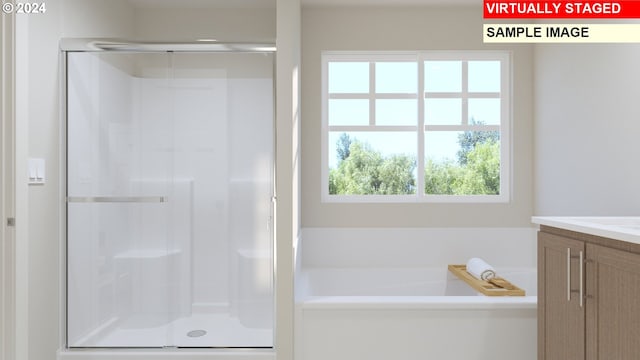 bathroom featuring separate shower and tub and vanity