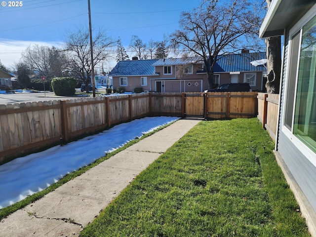 view of yard featuring a fenced backyard and a residential view