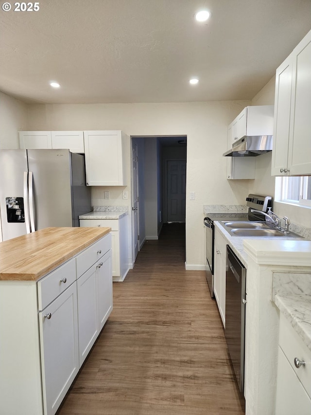 kitchen featuring under cabinet range hood, appliances with stainless steel finishes, and white cabinets