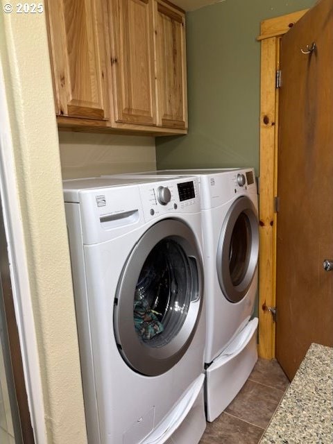 34851 Seavey Loop Rd, Eugene, OR 97405 - washroom featuring separate washer and dryer, cabinet space, and tile patterned flooring