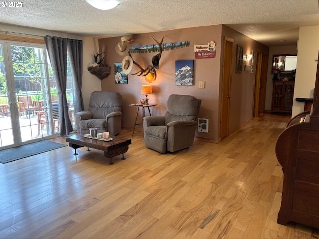 34851 Seavey Loop Rd, Eugene, OR 97405 - living area featuring a textured ceiling and light wood-type flooring