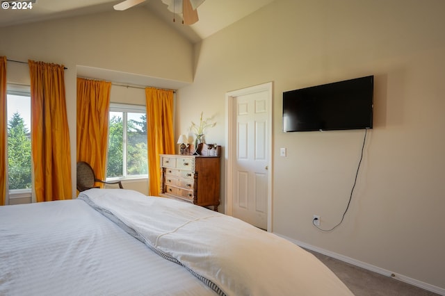 carpeted bedroom with ceiling fan and vaulted ceiling