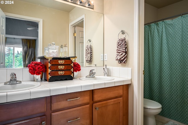 bathroom featuring a shower with curtain, tile patterned flooring, vanity, and toilet