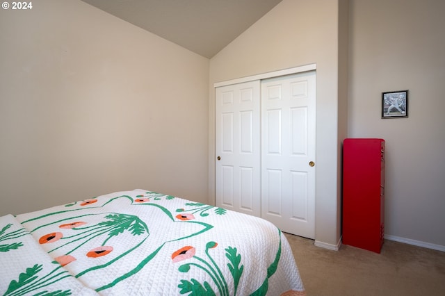 carpeted bedroom featuring vaulted ceiling and a closet