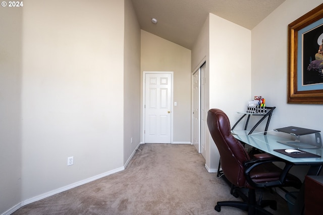 carpeted office space with high vaulted ceiling