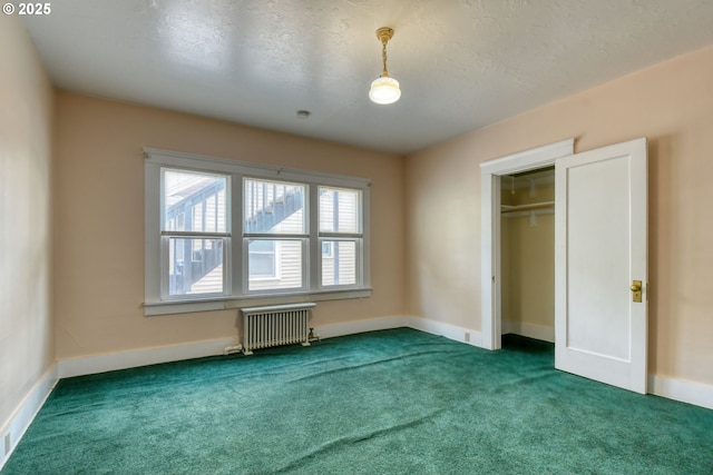 815 NW Bailey Ave, Pendleton, OR 97801 - unfurnished bedroom with radiator, carpet floors, a textured ceiling, and a closet