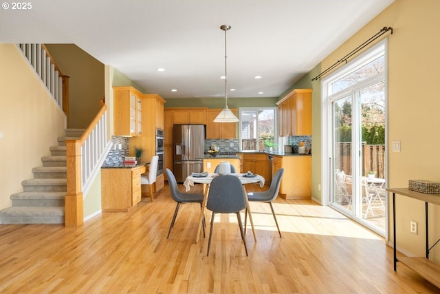 3816 NW Tustin Ranch Dr, Portland, OR 97229 - dining area with light wood-style floors, stairs, and recessed lighting