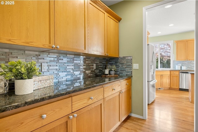 3816 NW Tustin Ranch Dr, Portland, OR 97229 - kitchen featuring stainless steel appliances, light wood finished floors, tasteful backsplash, dark stone countertops, and recessed lighting
