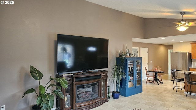 living room with baseboards, recessed lighting, a ceiling fan, and lofted ceiling