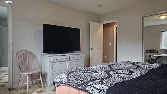 bedroom with baseboards and a textured ceiling