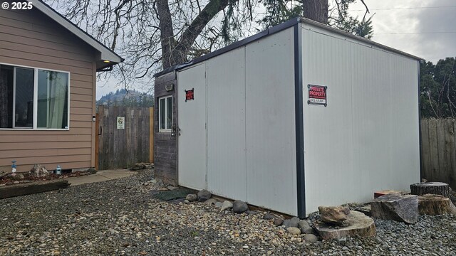 view of outbuilding featuring an outbuilding and fence