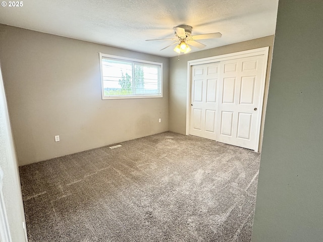 1903 N Eldorado Ave, Klamath Falls, OR 97601 - unfurnished bedroom with carpet, a closet, and a ceiling fan