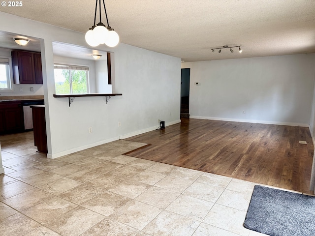 1903 N Eldorado Ave, Klamath Falls, OR 97601 - unfurnished living room with a textured ceiling and baseboards