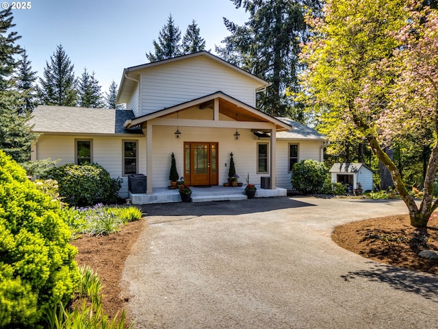 12720 S Carus Rd, Oregon City, OR 97045 - view of front of house with an outdoor structure, aphalt driveway, a porch, and a shed