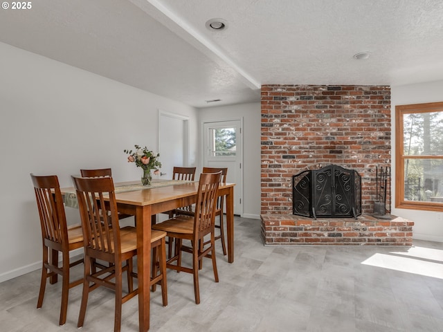 12720 S Carus Rd, Oregon City, OR 97045 - dining room featuring visible vents, a fireplace, baseboards, and a textured ceiling