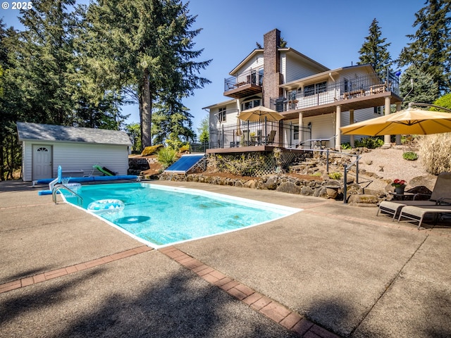 12720 S Carus Rd, Oregon City, OR 97045 - view of swimming pool featuring a patio area, an outbuilding, a covered pool, and a wooden deck