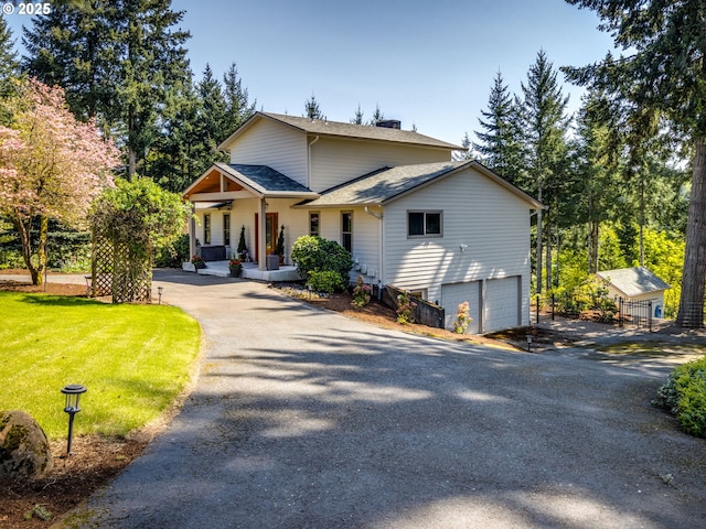 12720 S Carus Rd, Oregon City, OR 97045 - view of front of home with aphalt driveway, a front lawn, an attached garage, a porch, and roof with shingles