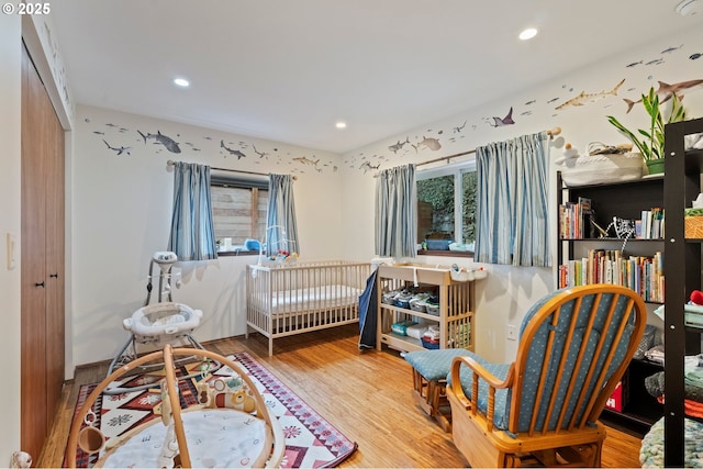 bedroom featuring hardwood / wood-style floors and a closet