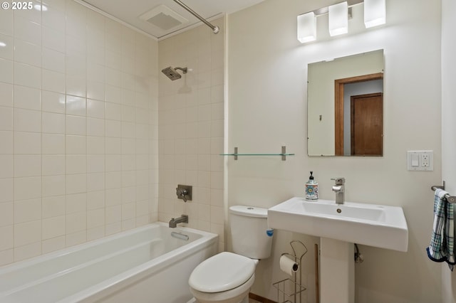 full bathroom with sink, toilet, and tiled shower / bath