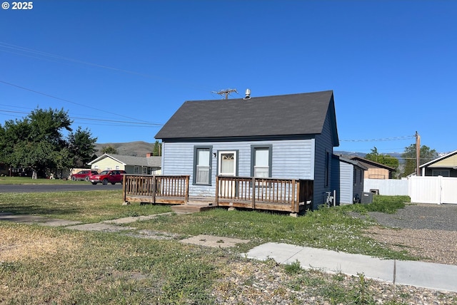 2909 College St, Baker City, OR 97814 - cape cod-style house featuring a wooden deck and roof with shingles