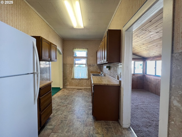 2909 College St, Baker City, OR 97814 - kitchen featuring freestanding refrigerator, light countertops, plenty of natural light, and wallpapered walls