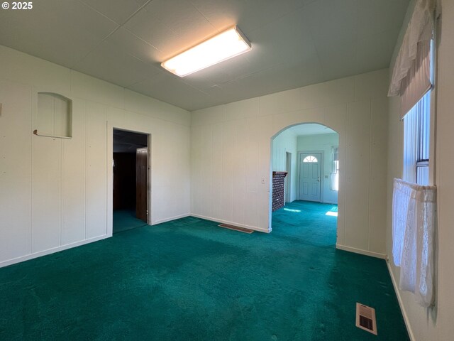 2909 College St, Baker City, OR 97814 - spare room featuring arched walkways and carpet flooring